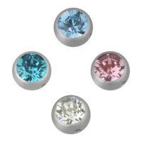 Vier silberne Piercingaufsätze mit Kristallen in Blau, Rosa und Kristallklar auf weißem Hintergrund
