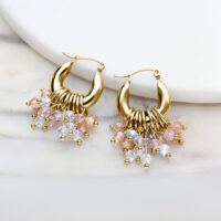 Goldene Creolen-Ohrringe mit bunten Kristallanhängern auf weißem Hintergrund